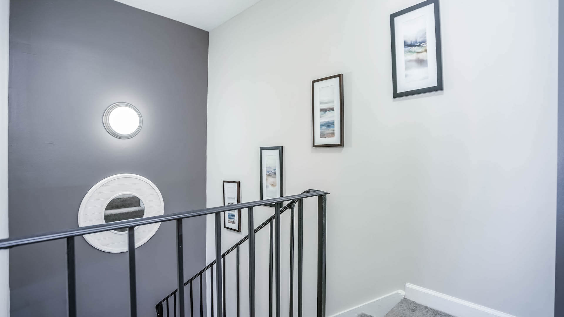 Stairwell in apartment decorated with photos and mirror