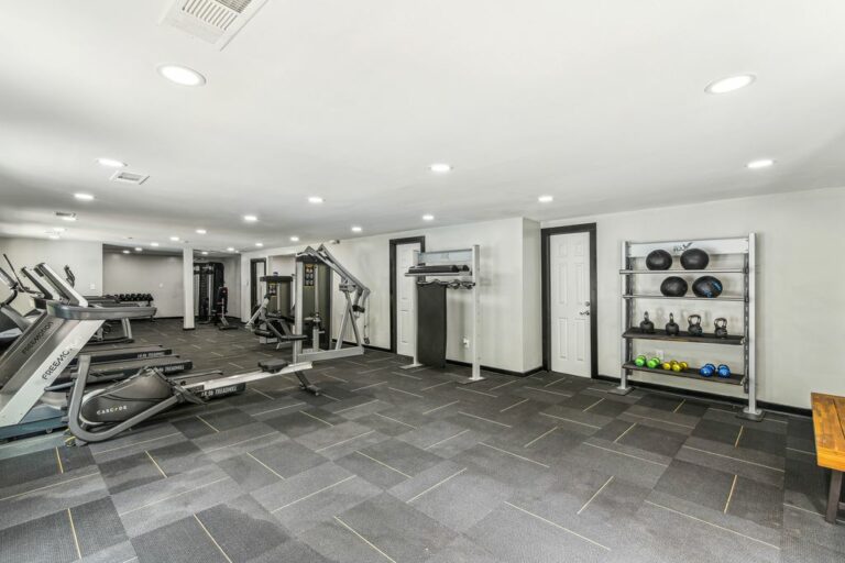 Fitness center with rowing machine, treadmills, and weight lifting machines.